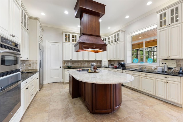 18258 Wayne Rd, Odessa, FL 33556 - kitchen featuring double oven, ornamental molding, a sink, decorative backsplash, and a kitchen island