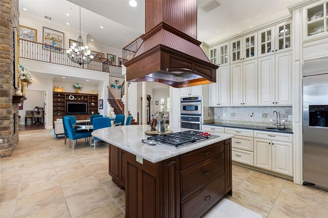 18258 Wayne Rd, Odessa, FL 33556 - kitchen with appliances with stainless steel finishes, a chandelier, tasteful backsplash, glass insert cabinets, and dark stone counters