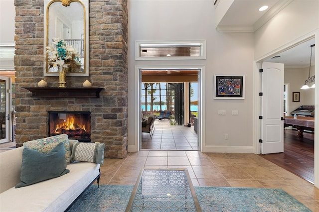 18258 Wayne Rd, Odessa, FL 33556 - tiled foyer featuring ornamental molding, a fireplace, baseboards, and a high ceiling