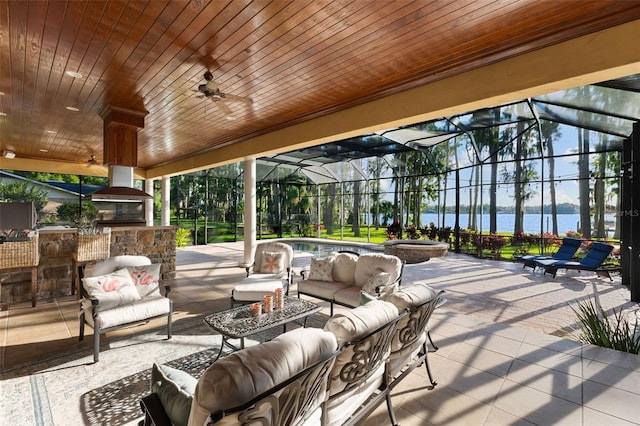 18258 Wayne Rd, Odessa, FL 33556 - view of patio / terrace featuring a water view, exterior kitchen, an outdoor living space, a ceiling fan, and glass enclosure