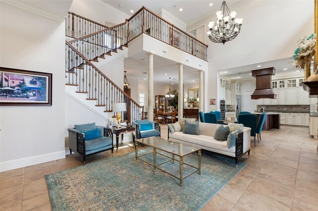 18258 Wayne Rd, Odessa, FL 33556 - living room with a chandelier, a towering ceiling, decorative columns, crown molding, and baseboards