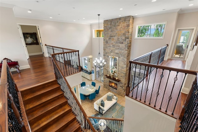 18258 Wayne Rd, Odessa, FL 33556 - stairs with wood finished floors, ornamental molding, a chandelier, baseboards, and recessed lighting