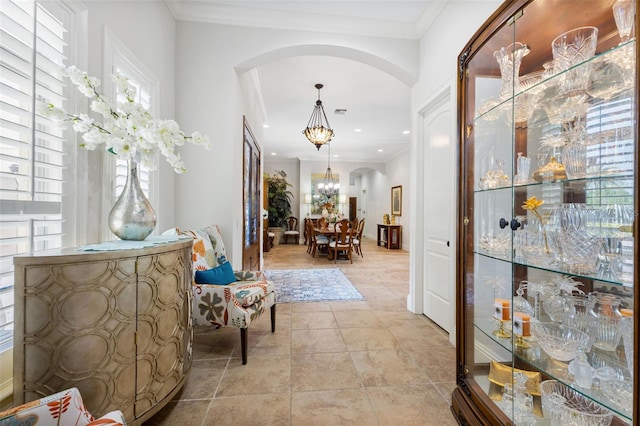 18258 Wayne Rd, Odessa, FL 33556 - hallway featuring arched walkways, crown molding, light tile patterned floors, a chandelier, and recessed lighting
