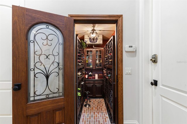 18258 Wayne Rd, Odessa, FL 33556 - wine cellar with brick patterned floors and a chandelier