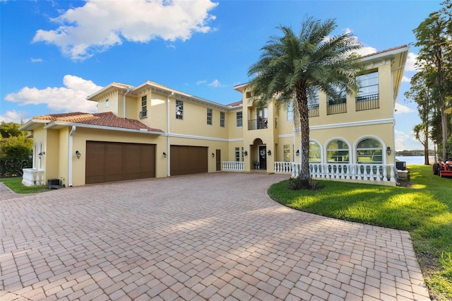 18258 Wayne Rd, Odessa, FL 33556 - mediterranean / spanish-style house featuring stucco siding, decorative driveway, a front lawn, a balcony, and a porch