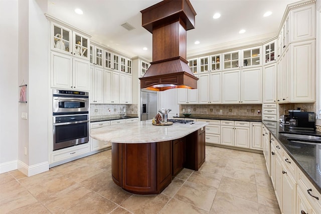 18258 Wayne Rd, Odessa, FL 33556 - kitchen with stainless steel appliances, decorative backsplash, dark stone counters, baseboards, and a kitchen island