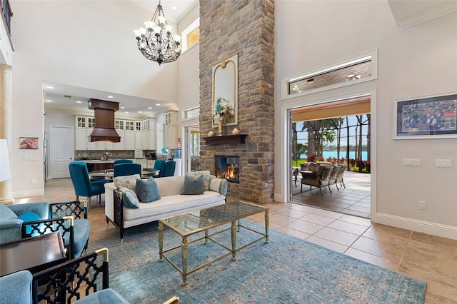18258 Wayne Rd, Odessa, FL 33556 - living room with a high ceiling, baseboards, a chandelier, light tile patterned floors, and a fireplace