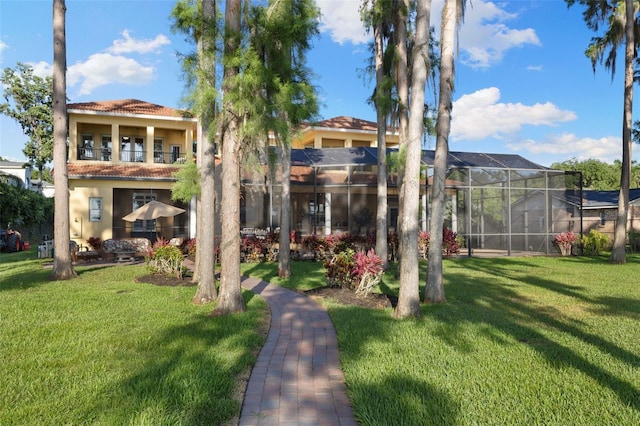 18258 Wayne Rd, Odessa, FL 33556 - back of house featuring a tiled roof, a yard, stucco siding, and glass enclosure