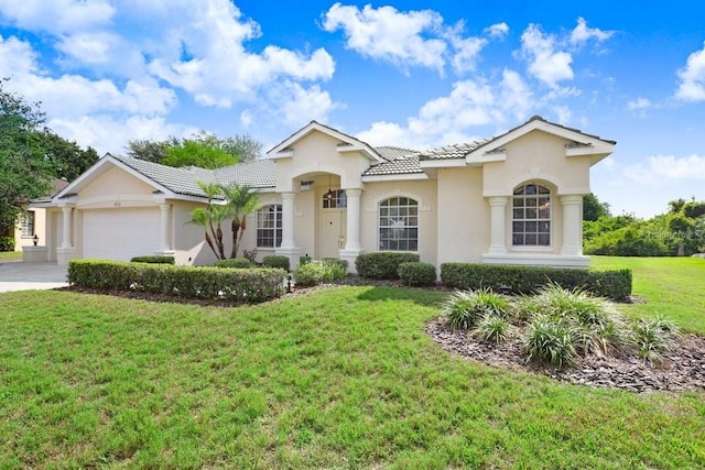 1212 Baycove Ln, Lutz, FL 33549 - mediterranean / spanish house with a tiled roof, a garage, a front lawn, and stucco siding