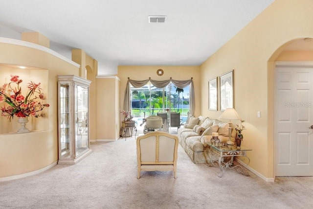 1212 Baycove Ln, Lutz, FL 33549 - carpeted living area featuring arched walkways and baseboards