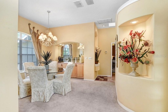 1212 Baycove Ln, Lutz, FL 33549 - dining room featuring arched walkways, light colored carpet, a chandelier, and baseboards