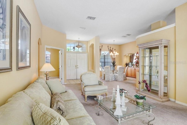 1212 Baycove Ln, Lutz, FL 33549 - carpeted living area with arched walkways, a chandelier, and baseboards