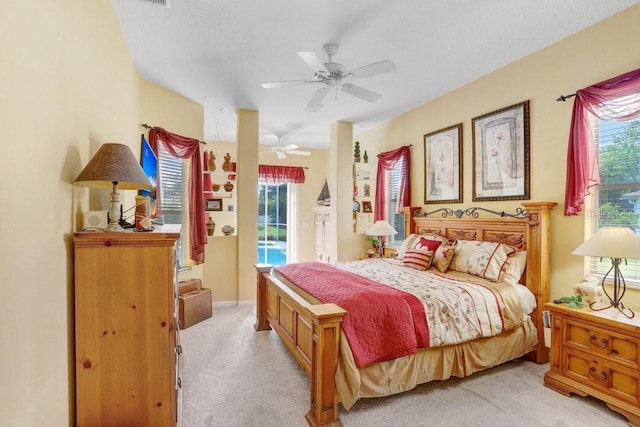 1212 Baycove Ln, Lutz, FL 33549 - bedroom featuring access to outside, light carpet, multiple windows, and ceiling fan
