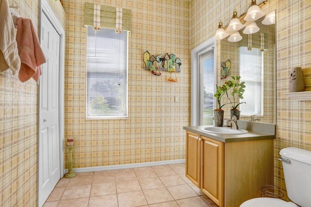 1212 Baycove Ln, Lutz, FL 33549 - bathroom with vanity, toilet, baseboards, wallpapered walls, and tile patterned flooring