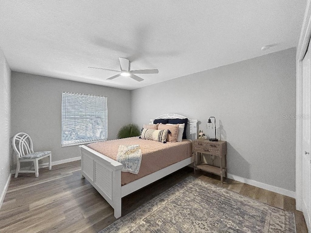 10011 46th Ave W, Bradenton, FL 34210 - bedroom with wood finished floors, baseboards, a textured ceiling, and a ceiling fan