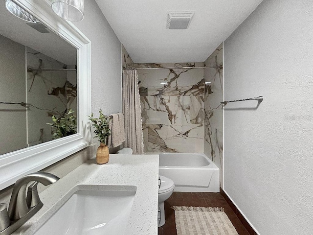 10011 46th Ave W, Bradenton, FL 34210 - bathroom featuring toilet, shower / tub combo, a textured wall, and vanity