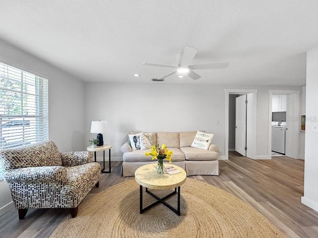 10011 46th Ave W, Bradenton, FL 34210 - living area featuring wood finished floors, baseboards, washing machine and dryer, and recessed lighting