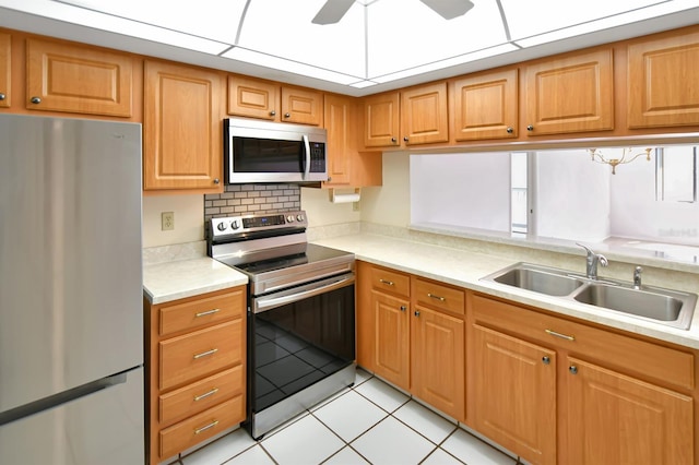 2593 Countryside Blvd Unit 7305, Clearwater, FL 33761 - kitchen featuring stainless steel appliances, a sink, light countertops, and light tile patterned floors