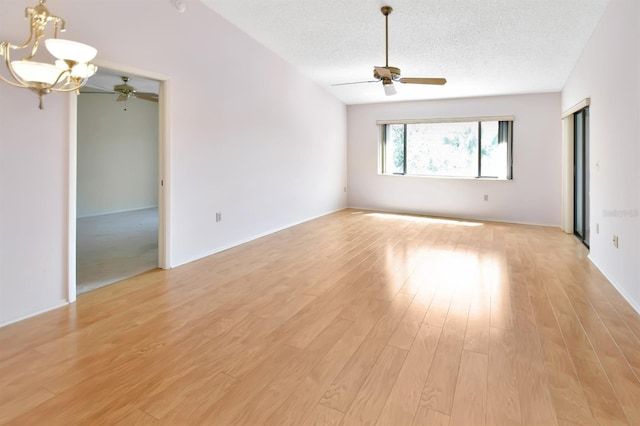2593 Countryside Blvd Unit 7305, Clearwater, FL 33761 - unfurnished room with a ceiling fan, a chandelier, a textured ceiling, and light wood-style flooring