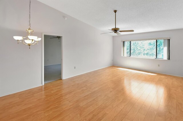 2593 Countryside Blvd Unit 7305, Clearwater, FL 33761 - empty room featuring ceiling fan, a chandelier, light wood-style floors, and a textured ceiling