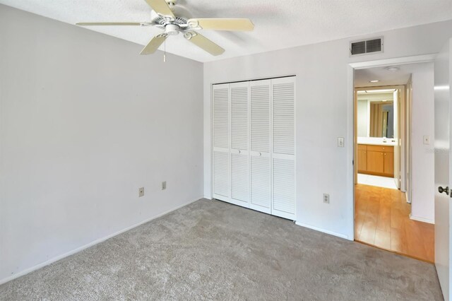 2593 Countryside Blvd Unit 7305, Clearwater, FL 33761 - unfurnished bedroom with light carpet, a closet, baseboards, and ceiling fan