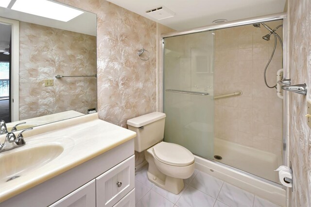 2593 Countryside Blvd Unit 7305, Clearwater, FL 33761 - bathroom with wallpapered walls, a shower stall, tile patterned floors, vanity, and toilet