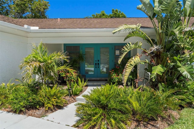 60 Lakeview Ct, Palm Harbor, FL 34683 - doorway to property with french doors and roof with shingles