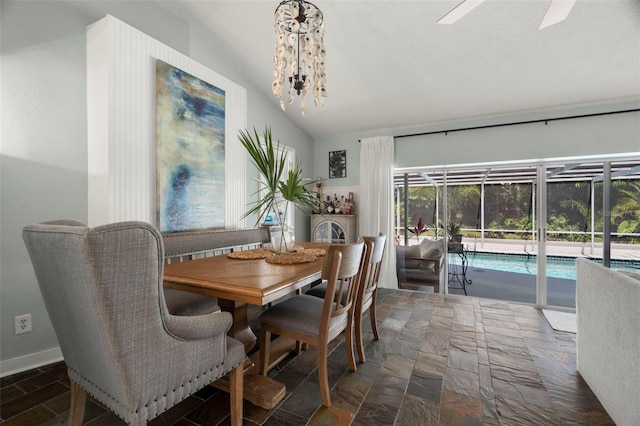 60 Lakeview Ct, Palm Harbor, FL 34683 - dining area with lofted ceiling, a chandelier, ceiling fan, and stone finish floors