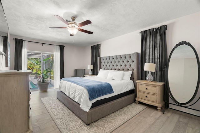60 Lakeview Ct, Palm Harbor, FL 34683 - bedroom with access to exterior, light wood-type flooring, a textured ceiling, and a ceiling fan