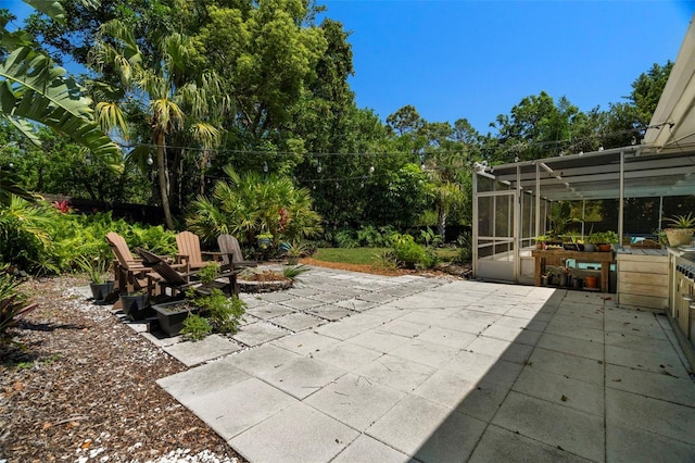60 Lakeview Ct, Palm Harbor, FL 34683 - view of patio featuring a fire pit and a sunroom
