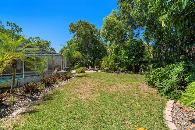 60 Lakeview Ct, Palm Harbor, FL 34683 - view of grassy yard with glass enclosure