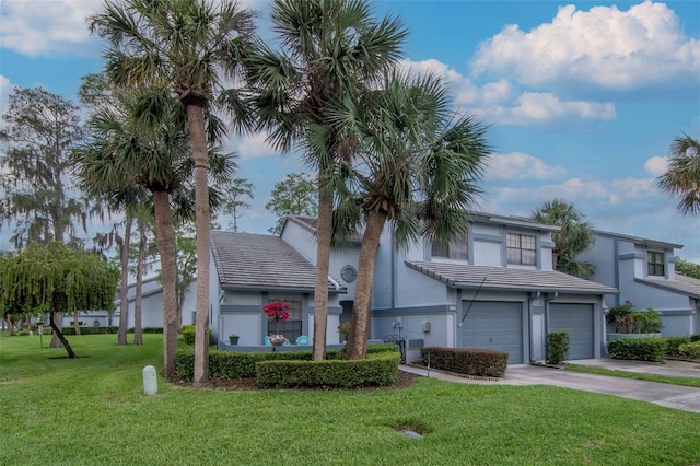 4234 Brentwood Park Cir, Tampa, FL 33624 - view of front of house with concrete driveway, an attached garage, stucco siding, and a tile roof