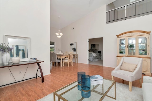 4234 Brentwood Park Cir, Tampa, FL 33624 - living room with high vaulted ceiling, a chandelier, wood finished floors, and baseboards
