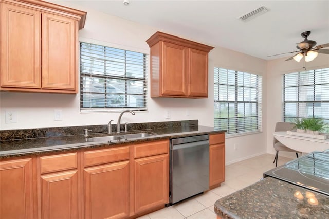 4234 Brentwood Park Cir, Tampa, FL 33624 - kitchen with stainless steel dishwasher, ceiling fan, light tile patterned floors, a sink, and dark stone counters