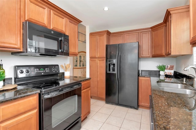 4234 Brentwood Park Cir, Tampa, FL 33624 - kitchen featuring black appliances, a sink, light tile patterned floors, dark stone countertops, and recessed lighting