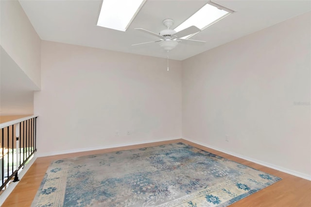 4234 Brentwood Park Cir, Tampa, FL 33624 - unfurnished room featuring ceiling fan, light wood-style flooring, a skylight, and baseboards