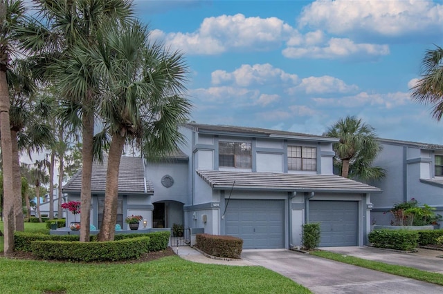 4234 Brentwood Park Cir, Tampa, FL 33624 - view of front of property featuring an attached garage, stucco siding, driveway, and a tile roof