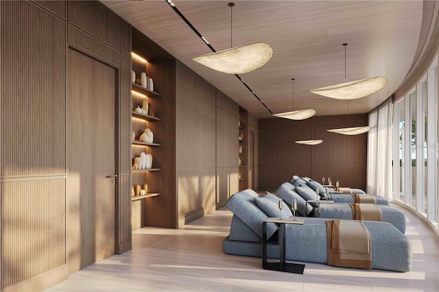805 S Gulfview Blvd Unit 602A, Clearwater, FL 33767 - cinema featuring built in shelves, light wood-type flooring, wooden walls, and a decorative wall