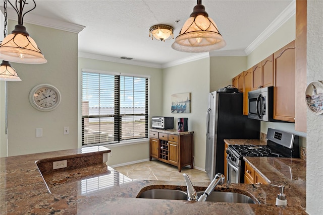2773 Via Cipriani Unit 1310A, Clearwater, FL 33764 - kitchen with stainless steel appliances, a sink, crown molding, brown cabinets, and dark stone counters