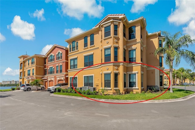 2773 Via Cipriani Unit 1310A, Clearwater, FL 33764 - view of property featuring uncovered parking