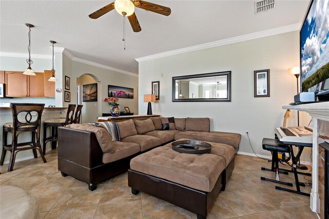 2773 Via Cipriani Unit 1310A, Clearwater, FL 33764 - living room with a ceiling fan, crown molding, arched walkways, baseboards, and light tile patterned floors