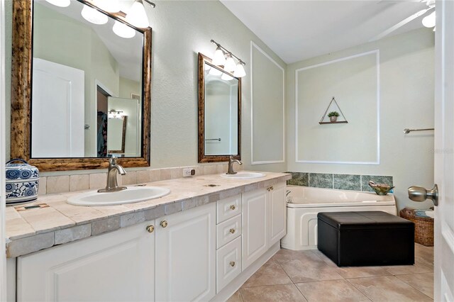2773 Via Cipriani Unit 1310A, Clearwater, FL 33764 - bathroom with tile patterned flooring, a garden tub, and double vanity