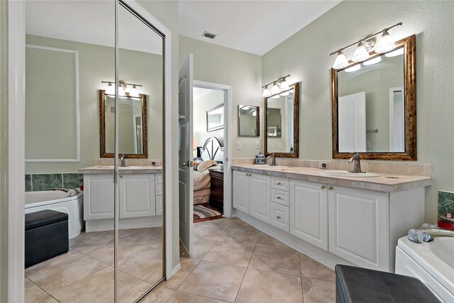 2773 Via Cipriani Unit 1310A, Clearwater, FL 33764 - full bath featuring double vanity, tile patterned flooring, and a bath