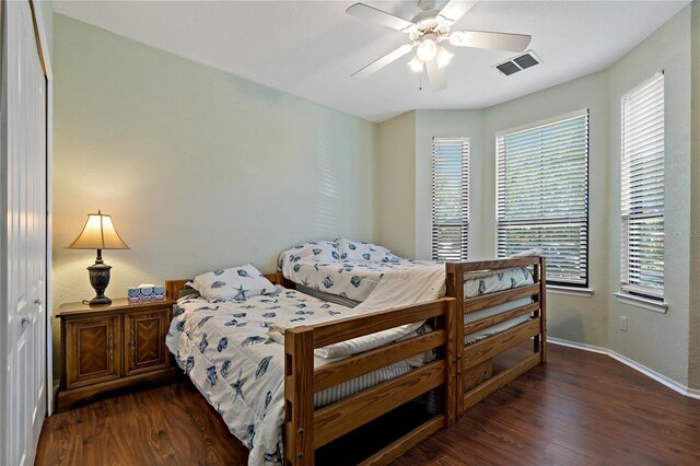 2773 Via Cipriani Unit 1310A, Clearwater, FL 33764 - bedroom with dark wood-style flooring, baseboards, and a ceiling fan