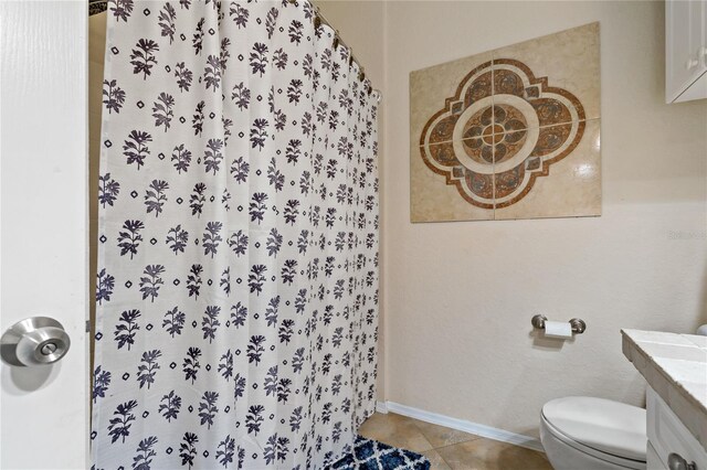 2773 Via Cipriani Unit 1310A, Clearwater, FL 33764 - full bathroom featuring toilet, tile patterned flooring, vanity, a shower with curtain, and baseboards