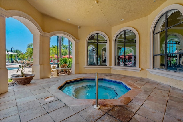 2773 Via Cipriani Unit 1310A, Clearwater, FL 33764 - view of swimming pool with a community hot tub and a patio