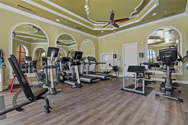 2773 Via Cipriani Unit 1310A, Clearwater, FL 33764 - gym with ceiling fan, crown molding, a tray ceiling, wood finished floors, and baseboards