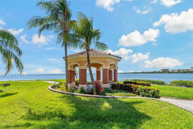 2773 Via Cipriani Unit 1310A, Clearwater, FL 33764 - community sign featuring a water view and a lawn