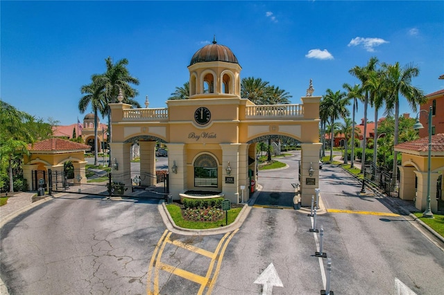 2773 Via Cipriani Unit 1310A, Clearwater, FL 33764 - view of asphalt street featuring a gate, a gated entry, and curbs