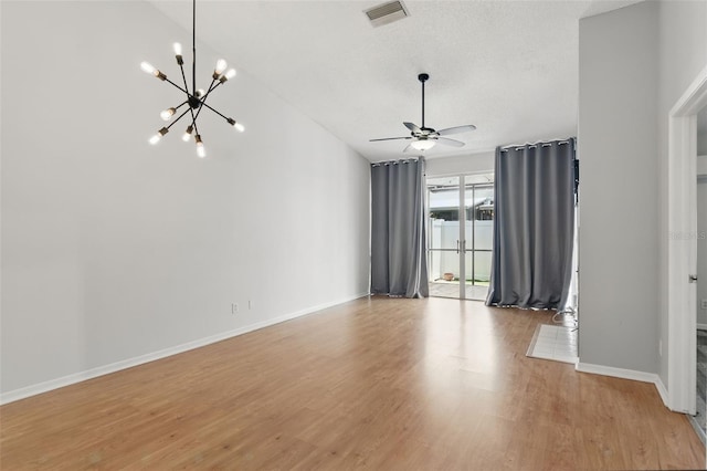 16109 Rambling Vine Dr E, Tampa, FL 33624 - unfurnished room with a chandelier, light wood-style floors, a ceiling fan, baseboards, and a textured ceiling